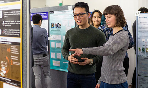 Two attendees at a poster presentation