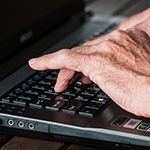 Person typing on laptop